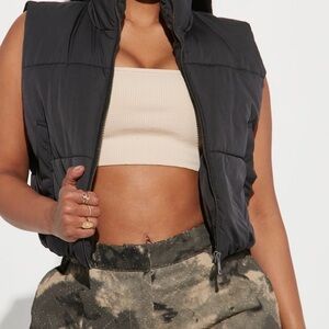 Black puffer vest with an adjustable waistband